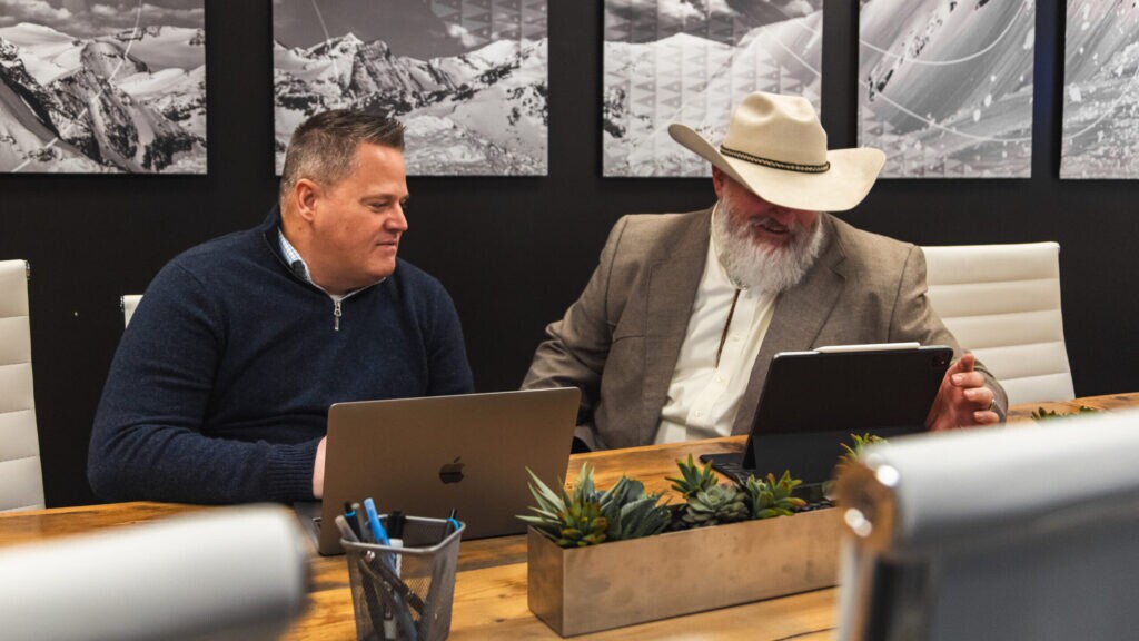 Two marketers working together on laptops