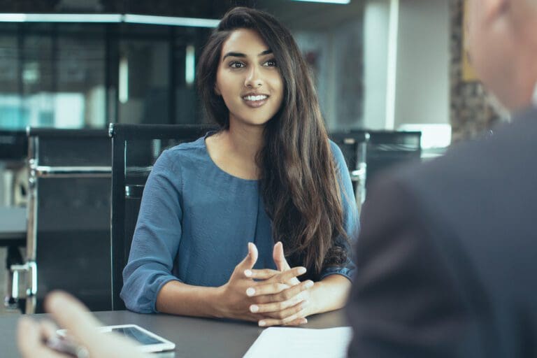 A woman in a meeting with another person.
